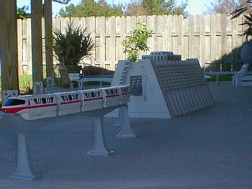 Close-up photograph of a model version of the Epcot monorail, set up on a patio